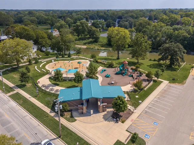 an aerial view of residential houses with outdoor space and trees