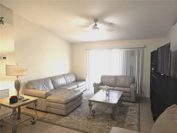 a living room with furniture and a lamp