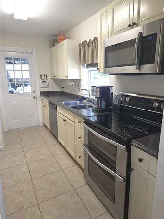 a kitchen with a stove microwave and sink