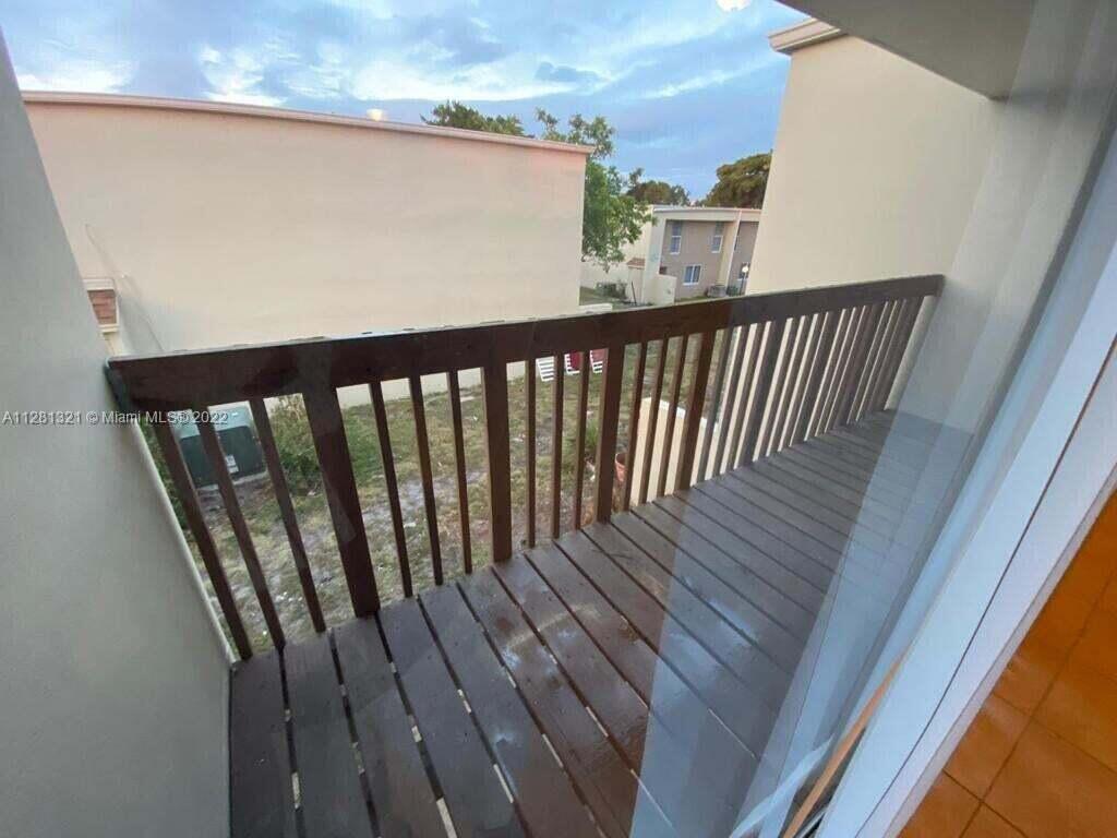 2800 Georgia Avenue, Unit 82 West Palm Beach, FL 33405 - Photo 11 of 12 a balcony with wooden floor