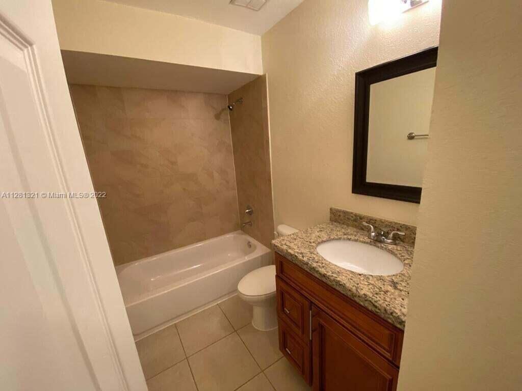 2800 Georgia Avenue, Unit 82 West Palm Beach, FL 33405 - Photo 9 of 12 a bathroom with a granite countertop sink toilet and shower