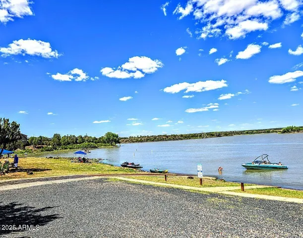 a view of a swimming pool with an outdoor seating a yard and ocean view