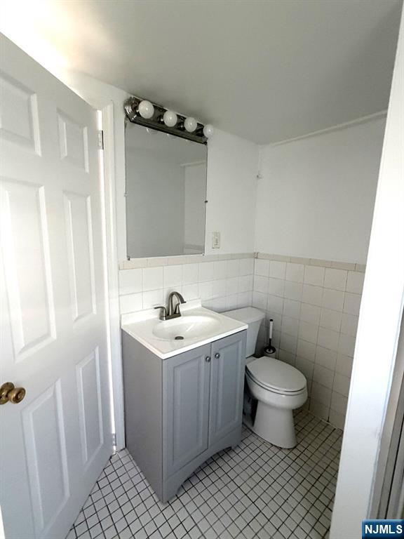 185 Hudson Street Hackensack, NJ 07601 - Photo 6 of 7 a bathroom with a sink toilet and vanity