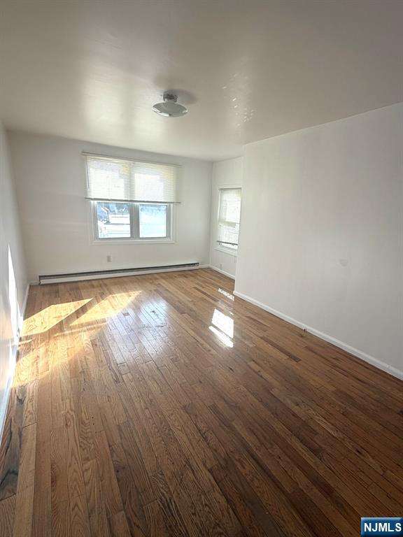 185 Hudson Street Hackensack, NJ 07601 - Photo 7 of 7 wooden floor in an empty room with a window