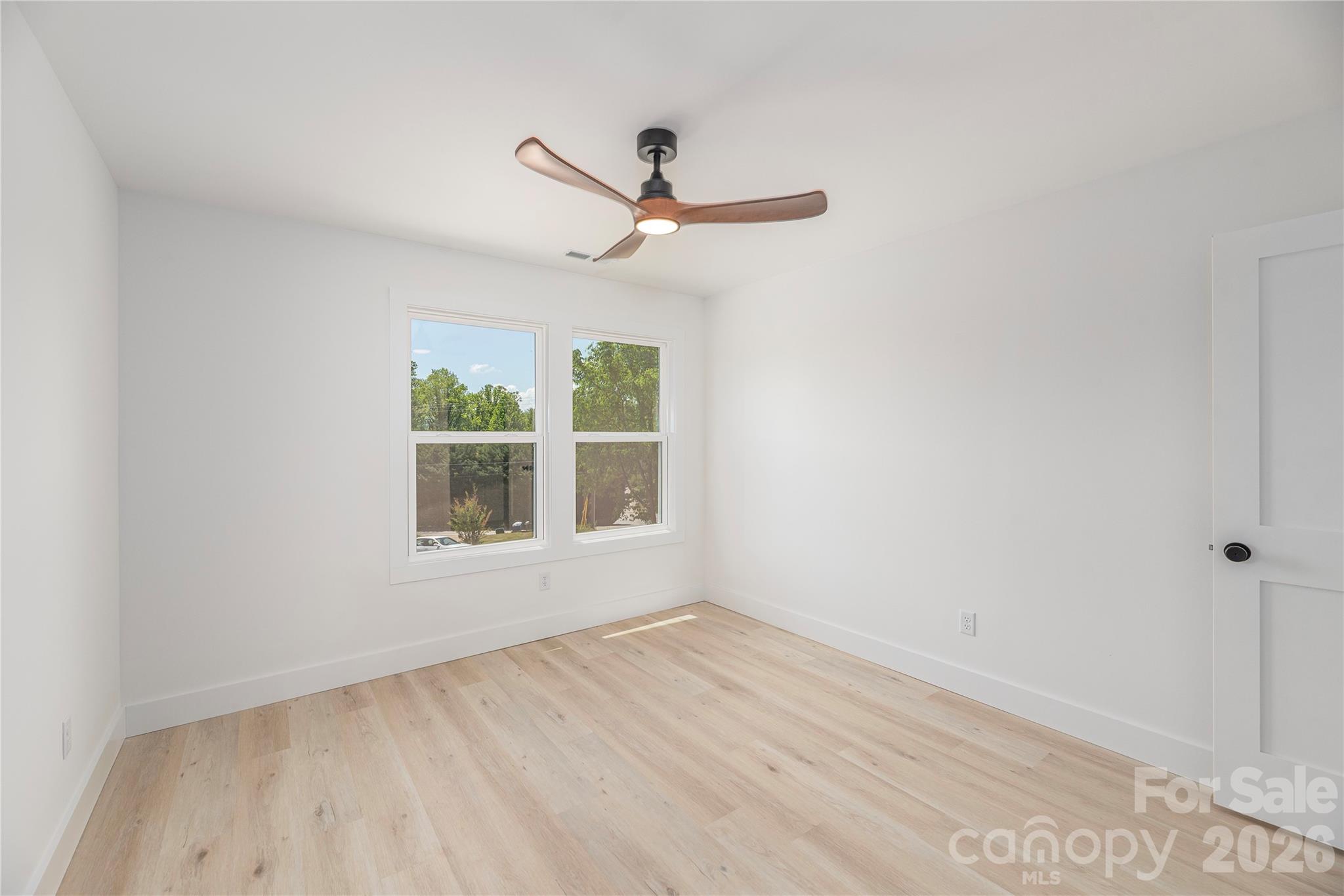 32 Oak Hill Road Candler, NC 28715 - Photo 21 of 29 a view of empty room with wooden floor and fan