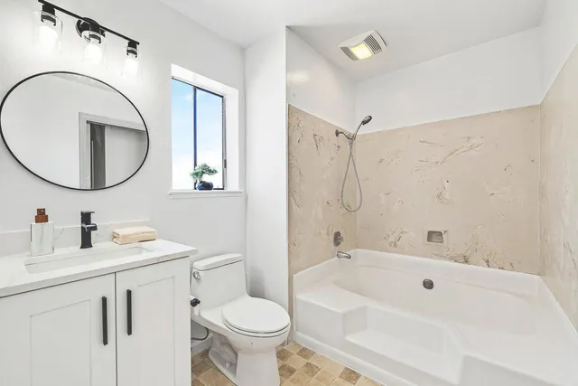 a bedroom with a bed and a large window