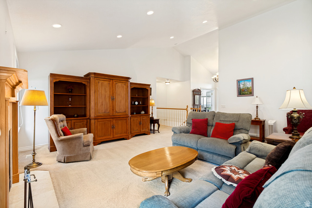 298 North Canyon Road Bountiful, UT 84010 - Photo 13 of 57 Spacious living area featuring vaulted ceilings, recessed lighting, and soft carpet flooring