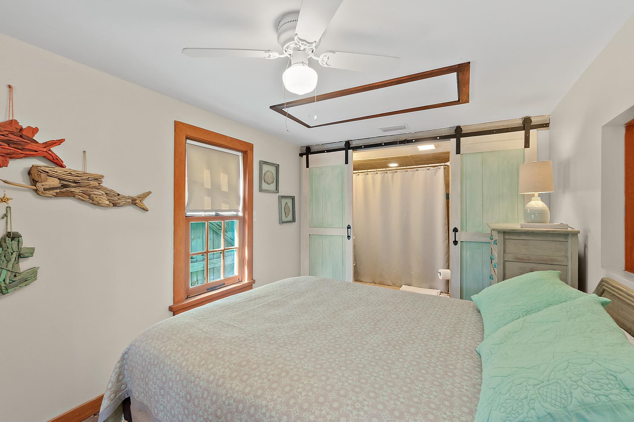 51 Beachcomber Way St. Augustine, FL 32084 - Photo 11 of 46 a bedroom with a bed and a chandelier