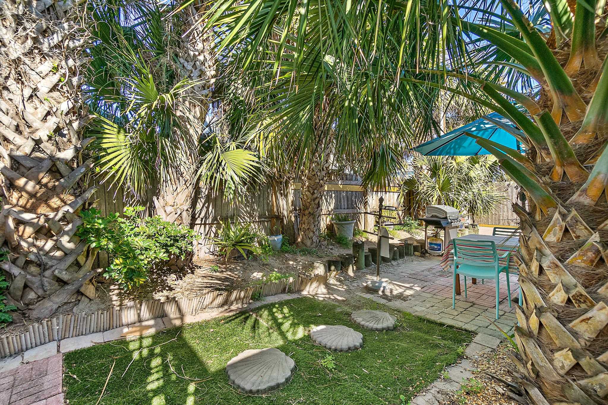 51 Beachcomber Way St. Augustine, FL 32084 - Photo 26 of 46 a view of a backyard with plants and a patio