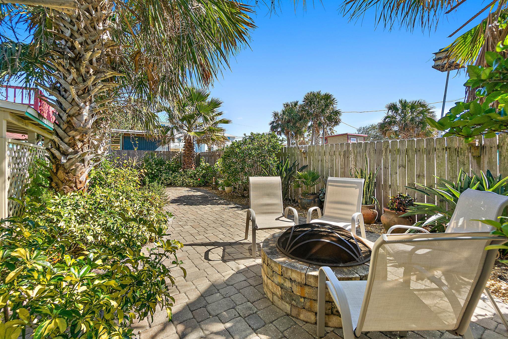 51 Beachcomber Way St. Augustine, FL 32084 - Photo 29 of 46 a view of a patio with table and chairs and potted plants with wooden fence