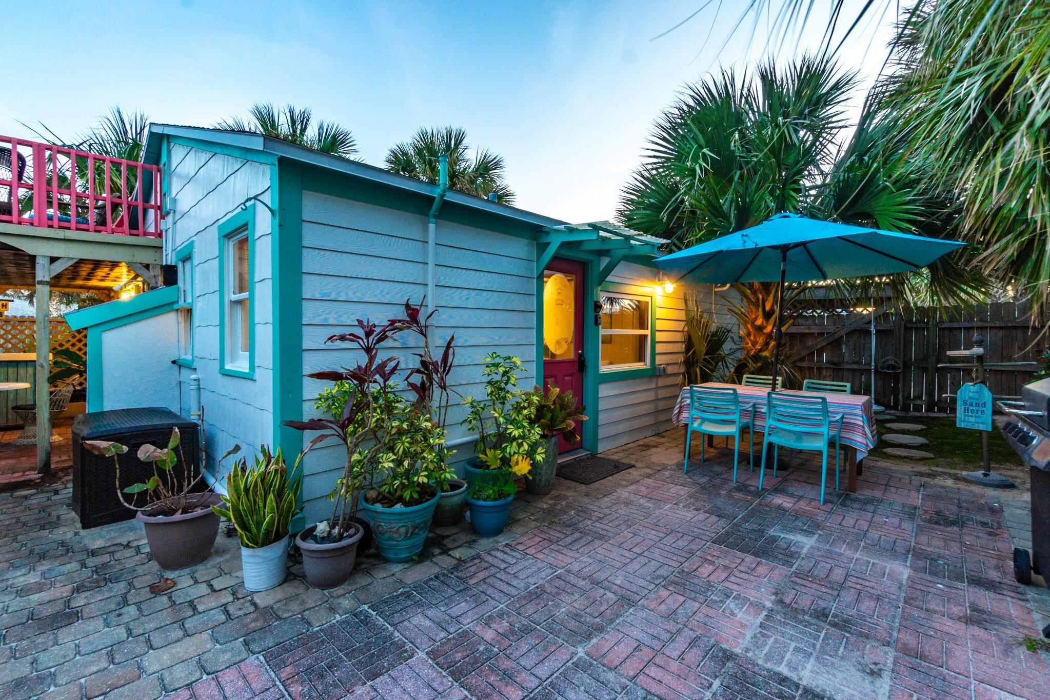 51 Beachcomber Way St. Augustine, FL 32084 - Photo 39 of 46 a view of a chairs and table under an umbrella in backyard
