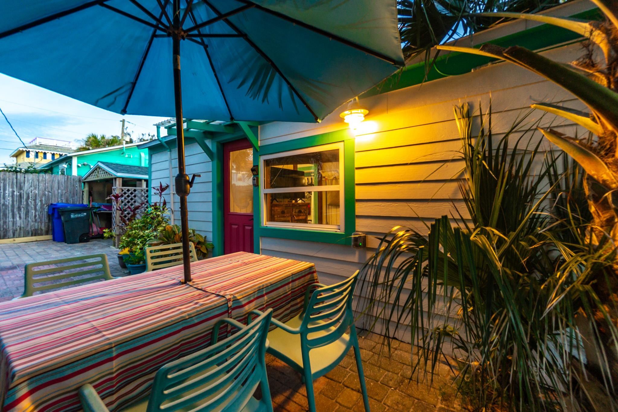 51 Beachcomber Way St. Augustine, FL 32084 - Photo 41 of 46 a view of a patio with a table and chairs under an umbrella