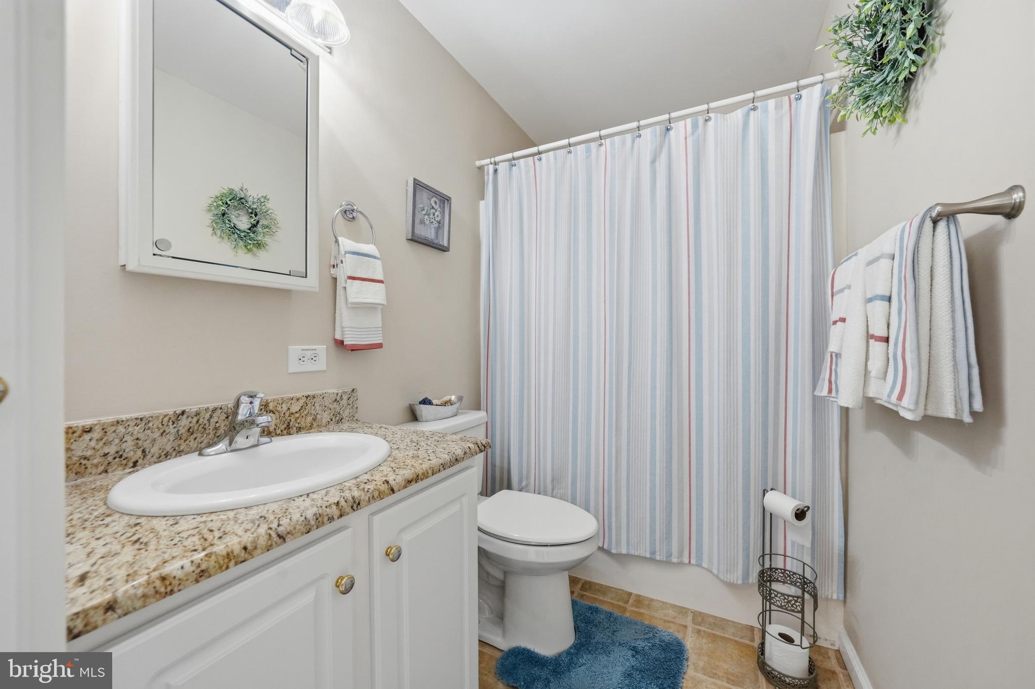 430 Rt Us 9 Street South, Unit 137 Marmora, NJ 08223 - Photo 13 of 24 a bathroom with a granite countertop sink toilet and a mirror