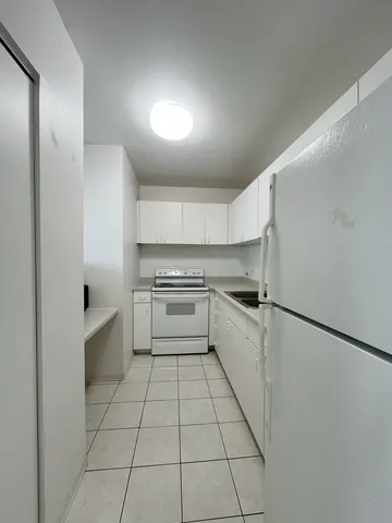 a kitchen with a cabinets and white appliances