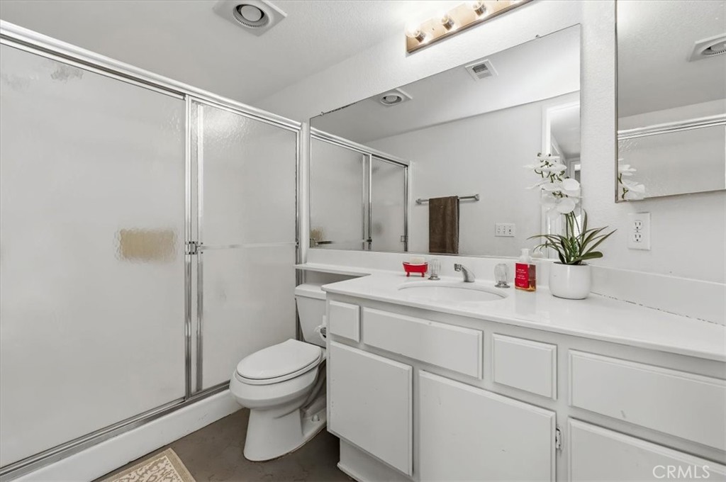 352 Leafwood Court Riverside, CA 92506 - Photo 22 of 42 a bathroom with a shower sink vanity mirror and toilet