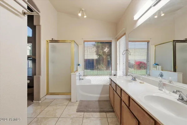 a bathroom with a tub sink and mirror