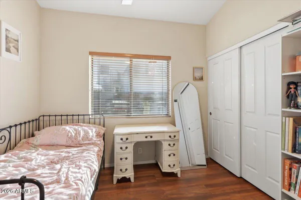 a bedroom with a bed and a large window