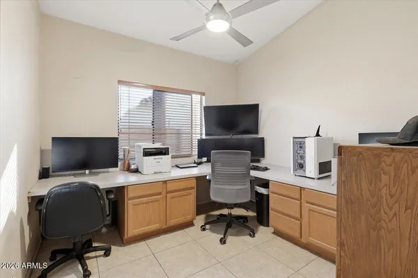 a view of a workspace with furniture and a window
