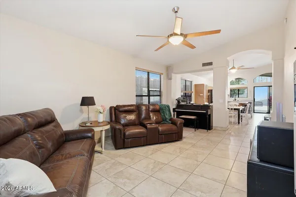 a living room with furniture and kitchen view