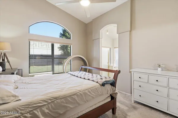 a bedroom with a bed and a large window