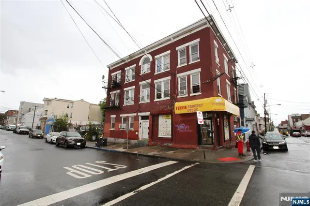 a view of a building with car parked