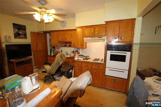 a kitchen with stainless steel appliances granite countertop a refrigerator stove top oven a sink and dishwasher