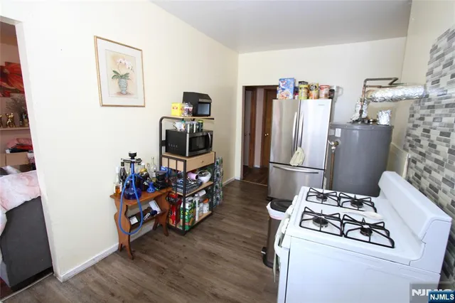 a kitchen that has a refrigerator and a stove