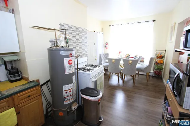 a view of a dining room with furniture a rug and wooden floor