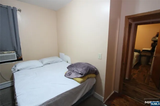 a bedroom with a bed and a mirror