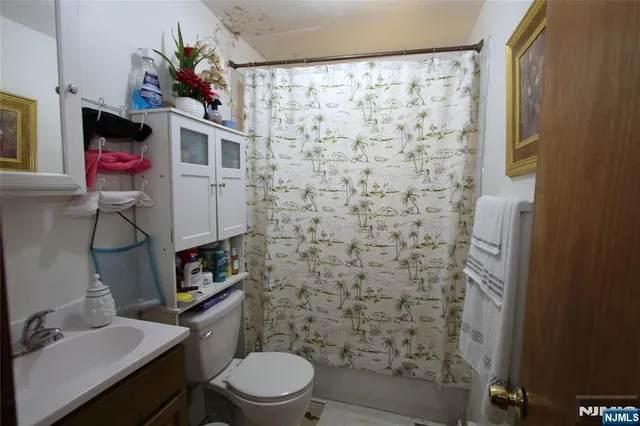 a bathroom with a toilet and a shower curtain