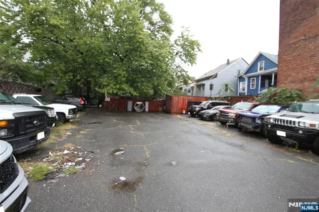 a couple of cars parked in front of a house