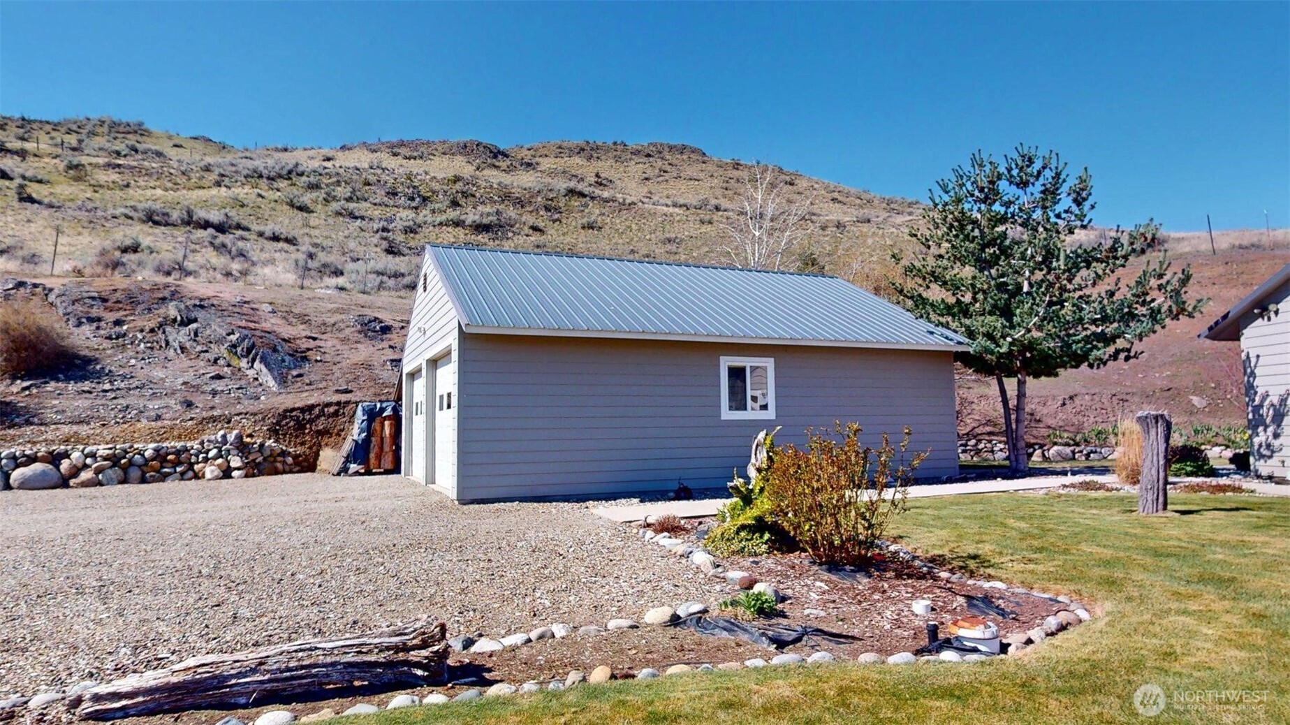 1811 Pine Creek Road Tonasket, WA 98855 - Photo 25 of 38 a front view of a house with a yard