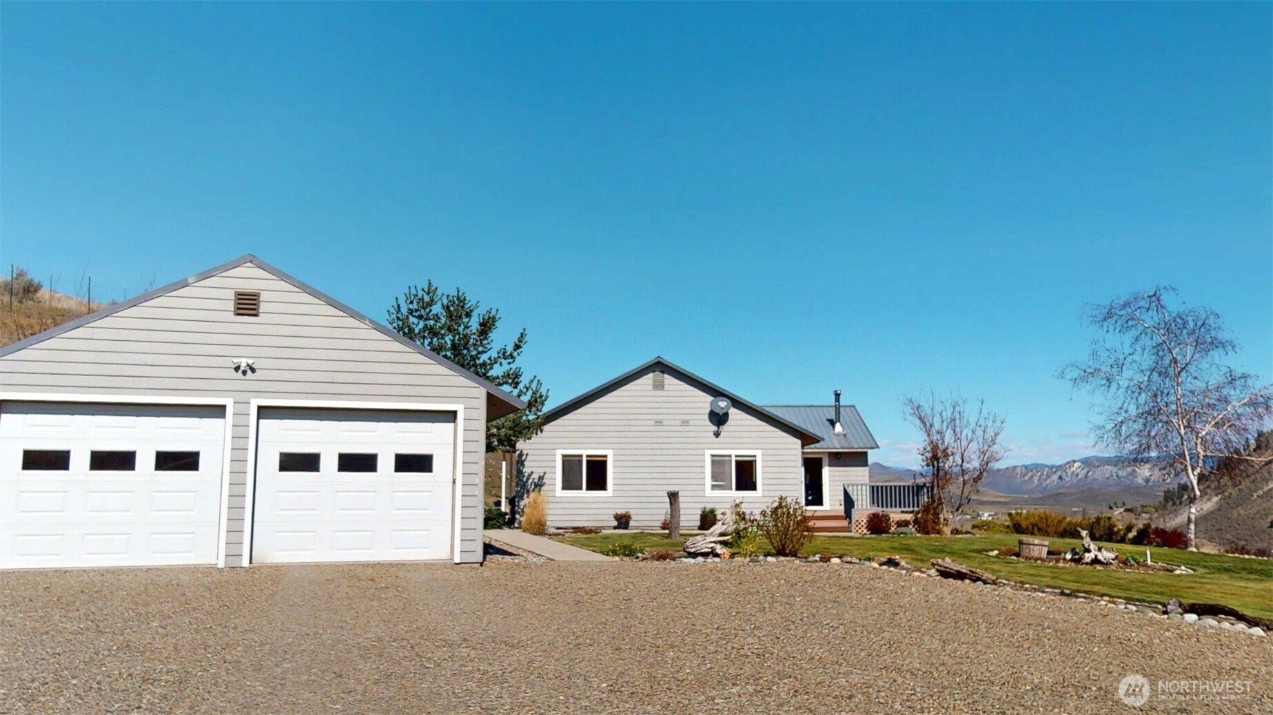 1811 Pine Creek Road Tonasket, WA 98855 - Photo 26 of 38 a big white house with a large tree in front of it