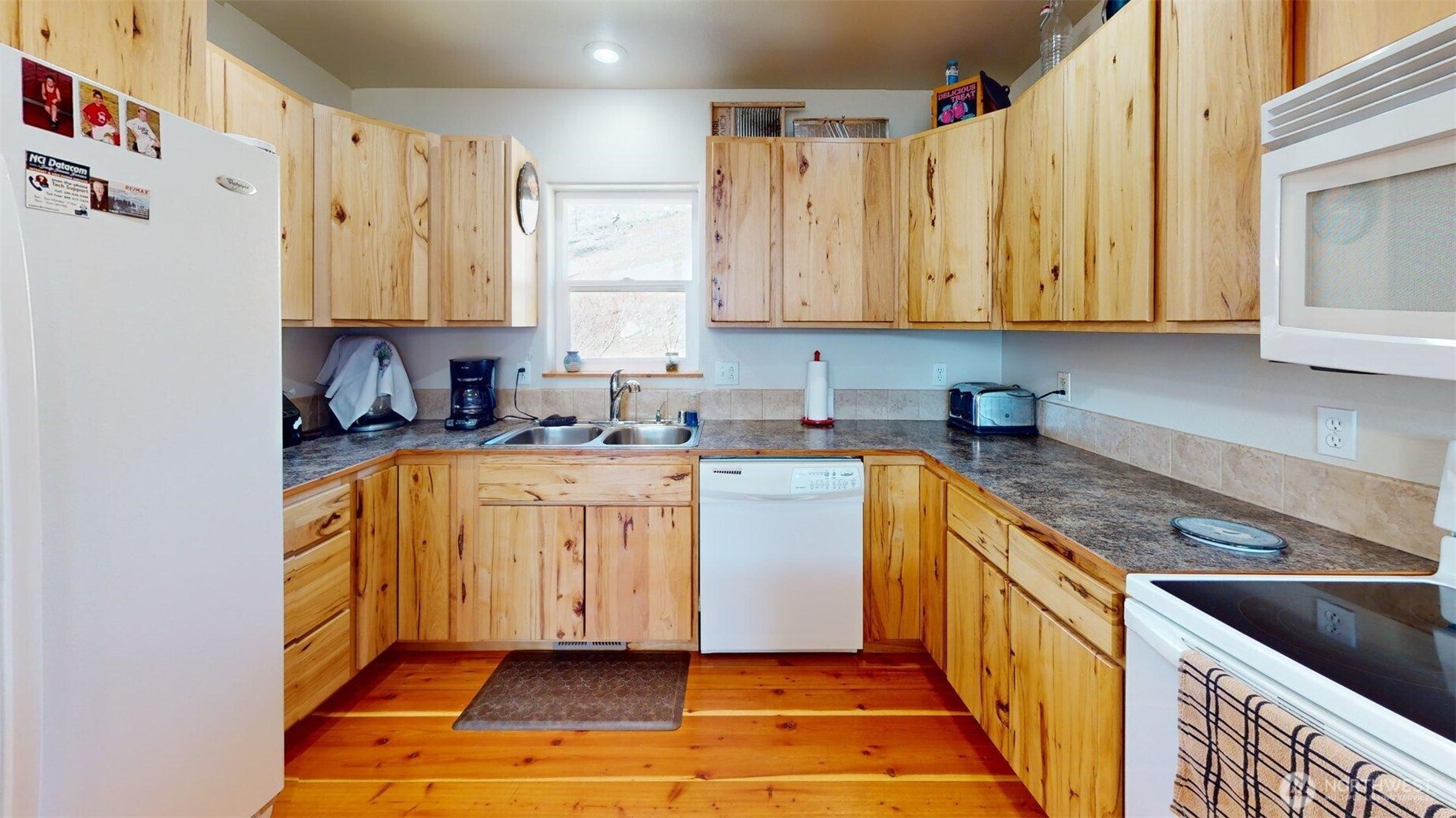 1811 Pine Creek Road Tonasket, WA 98855 - Photo 7 of 38 a kitchen with stainless steel appliances granite countertop a sink a stove and a refrigerator