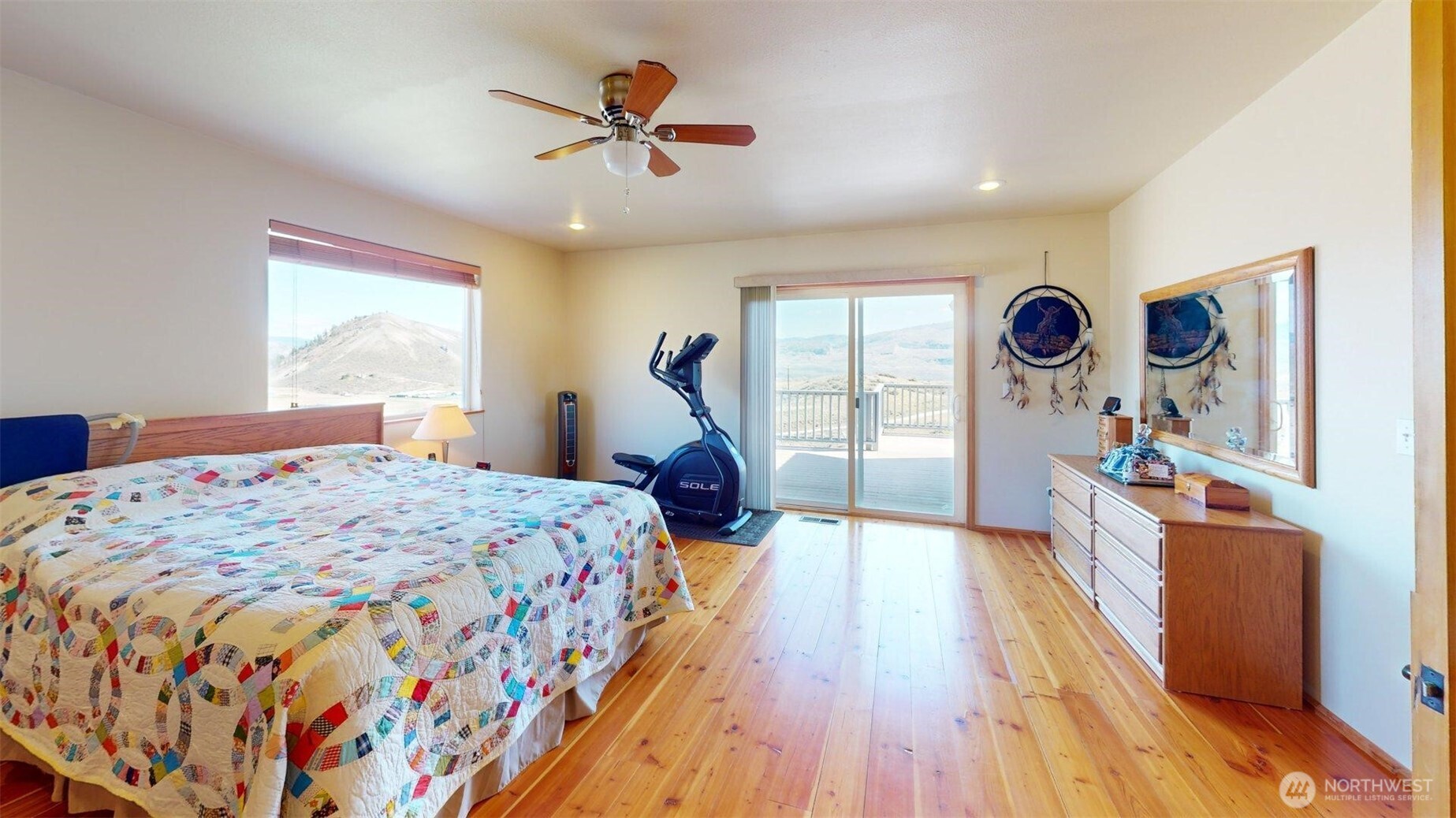 1811 Pine Creek Road Tonasket, WA 98855 - Photo 10 of 38 a bedroom with a bed and a chandelier