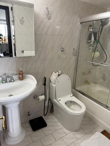 a white toilet sitting next to a bathroom sink