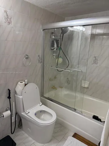a bathroom with a toilet and a shower