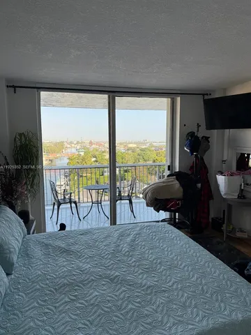a living room with furniture and a floor to ceiling window