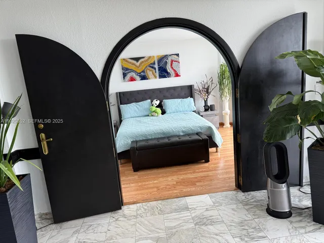 a bedroom with a bed and a potted plant