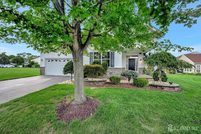 a front view of a house with backyard and sitting area