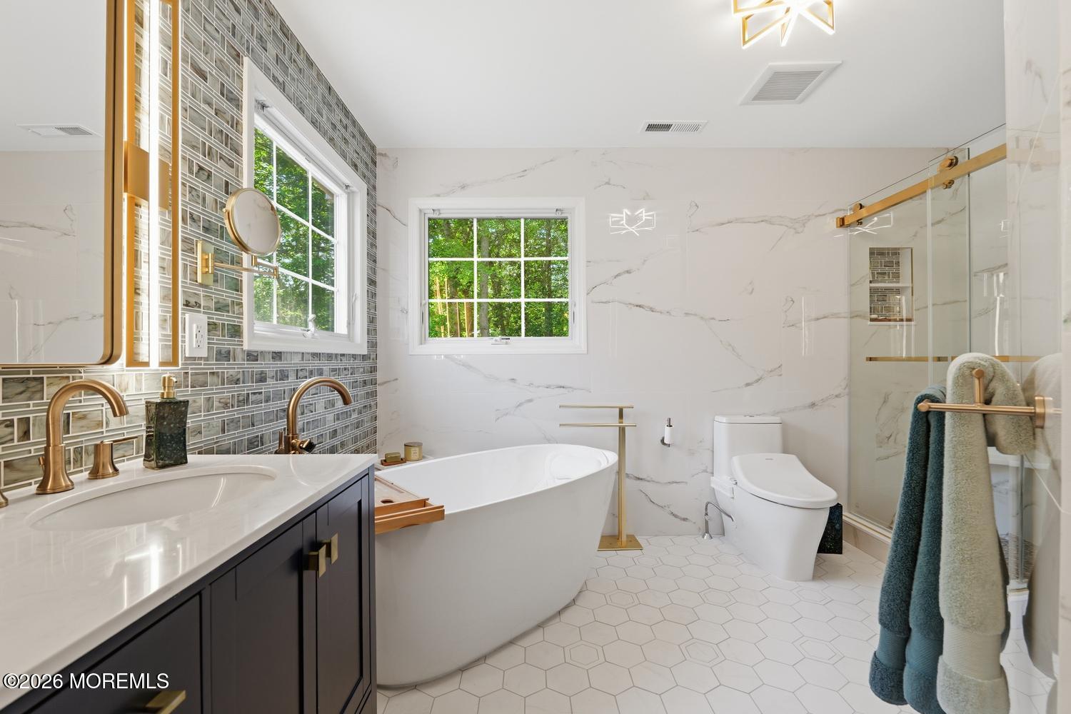 7 Cherry Tree Lane Cream Ridge, NJ 08514 - Photo 23 of 47 a bathroom with a double vanity sink a toilet a mirror and a tub