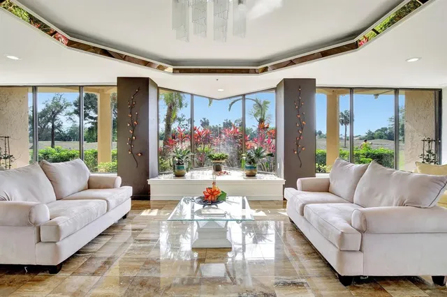 a living room with furniture and flowers