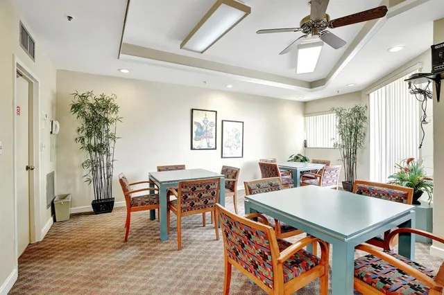 a living room with furniture a table and a potted plant