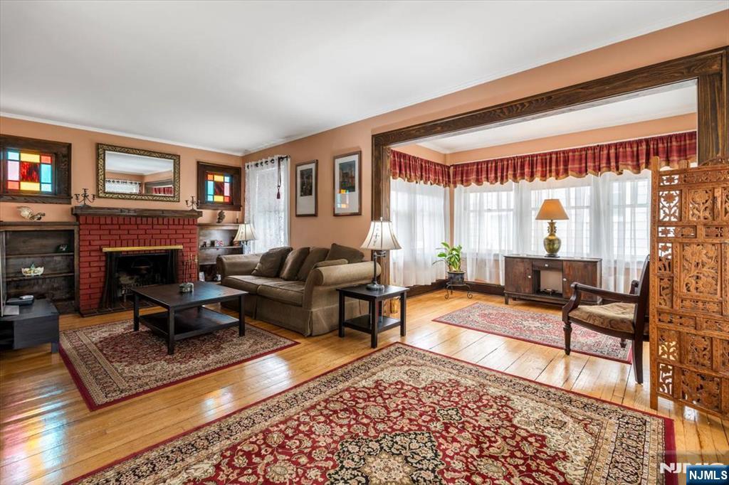 217 Mountain Way Rutherford, NJ 07070 - Photo 3 of 28 a living room with furniture a rug and a fireplace
