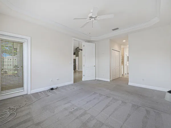 a spacious en suite bathroom with a granite countertop sink a mirror and a