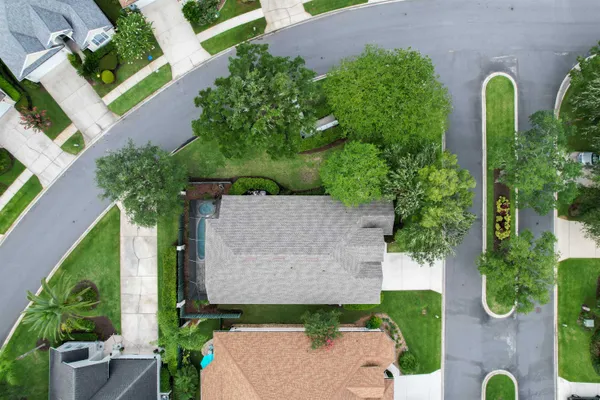 an aerial view of lake and residential houses with outdoor space