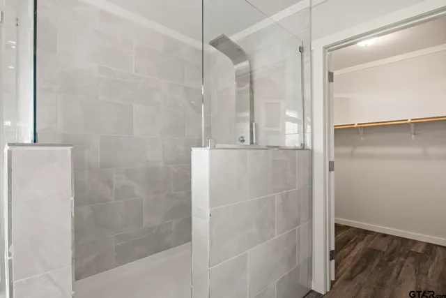 a bathroom with a glass shower door