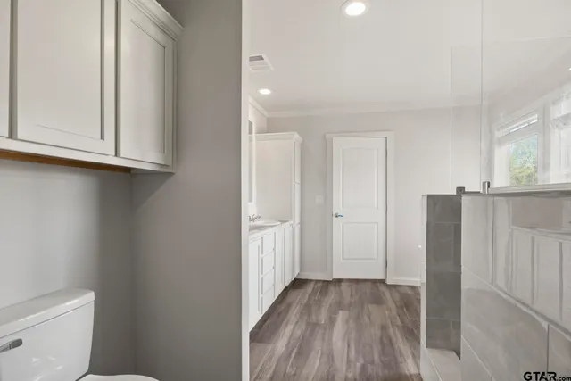 a view of closet area with wooden floor