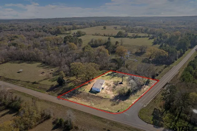 an aerial view of a house with a yard