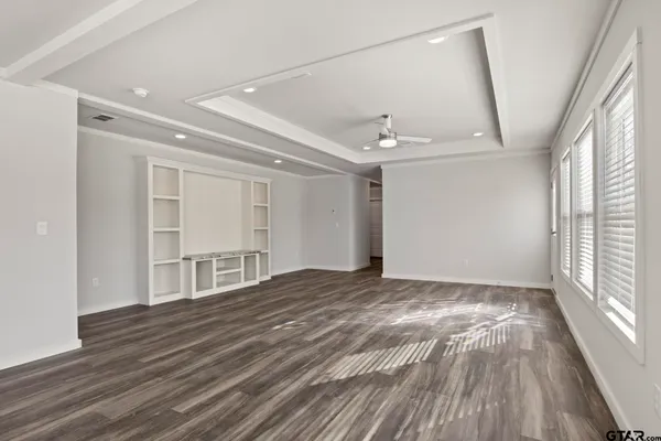 a view of a hallway with wooden floor and glass door